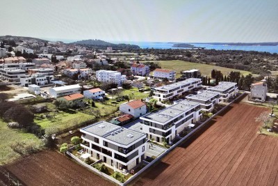 Sale of an apartment with a garden and parking space in a new residential complex, Štinjan! 10A