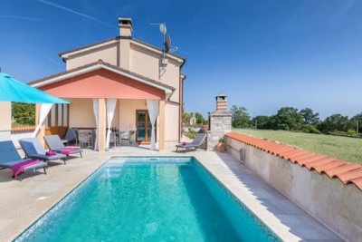 A beautiful house with a pool, surrounded by greenery!